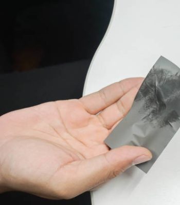 close up man hand holds dirty oil from his face after working